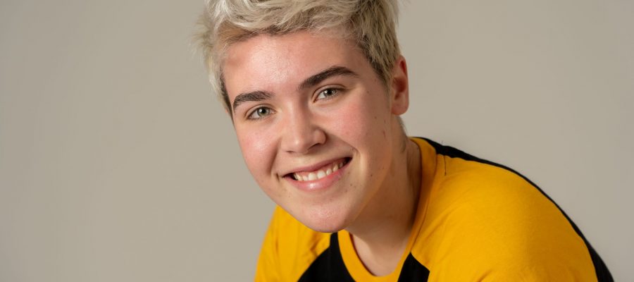 Beauty portrait of handsome young transgender teenager man model posing happy Portrait of young attractive stylish fashion teenager confident and happy with his gender identity. Trans boy posing in cool urban fashion t shirt. In Beauty, Transgender people and Equality concept.