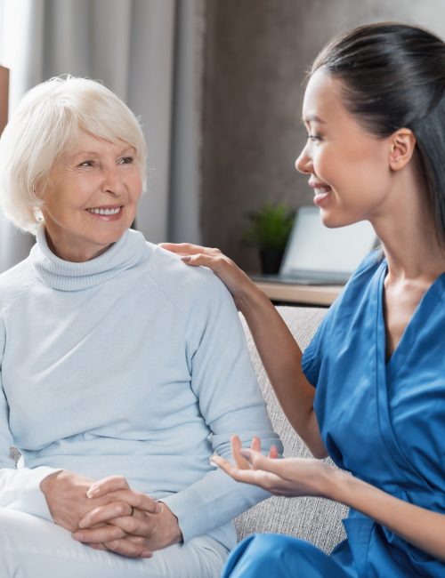 Nurse assisting with elderly woman at home Nurse assisting with elderly woman at home
